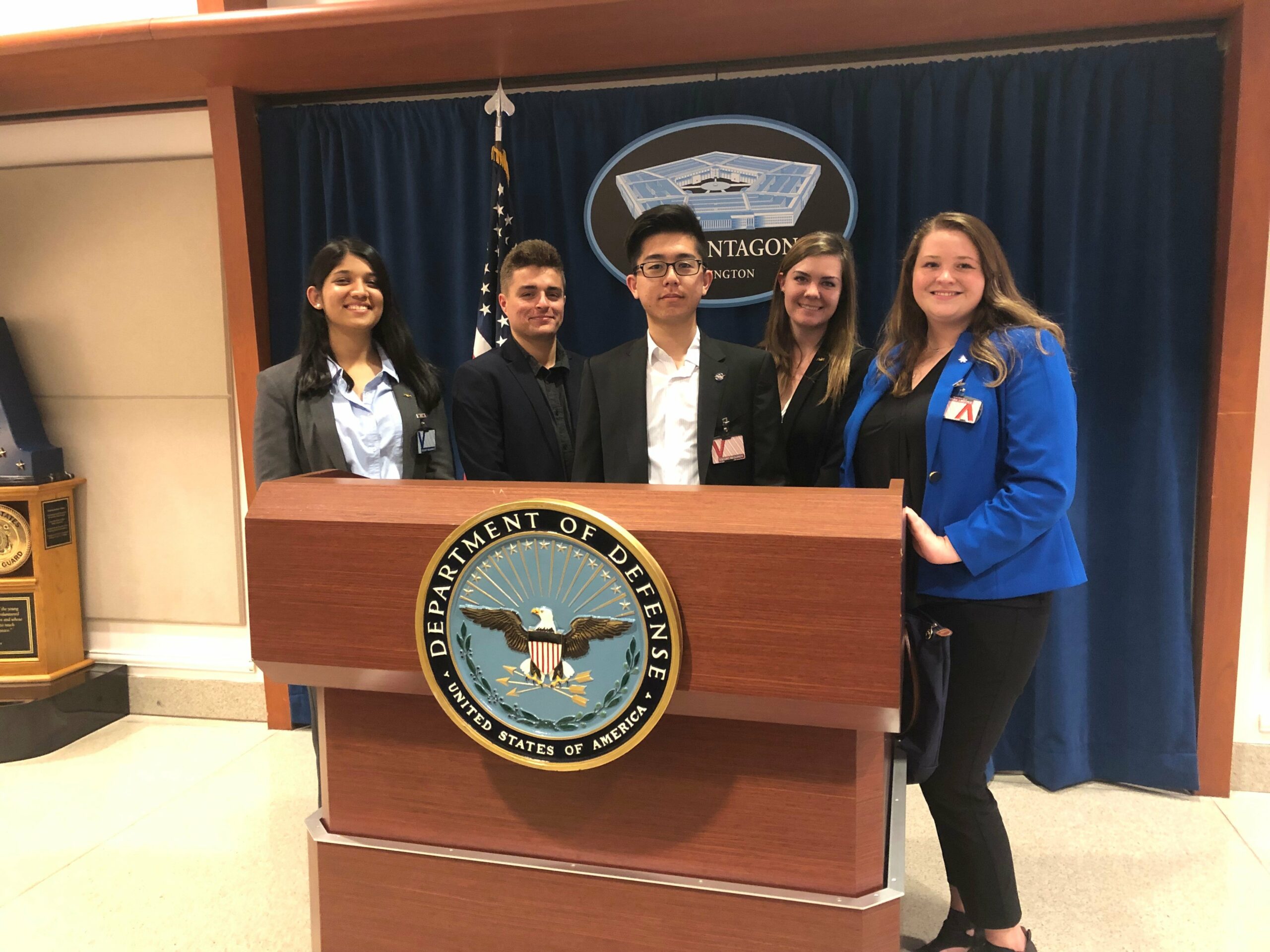 a group of people standing behind a podium