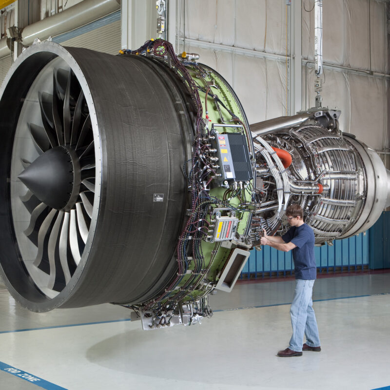 a person standing next to a large stack of tires